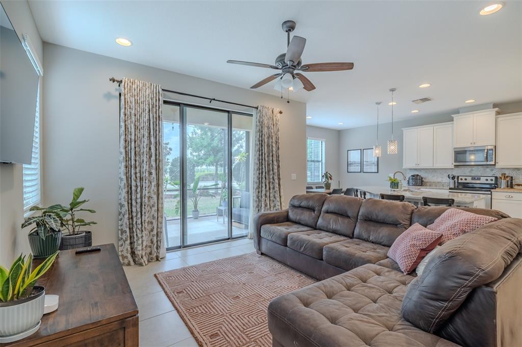4730 Wandering Way Wesley Chapel, FL 33544 - Photo 17 of 61 a living room with furniture and a large window