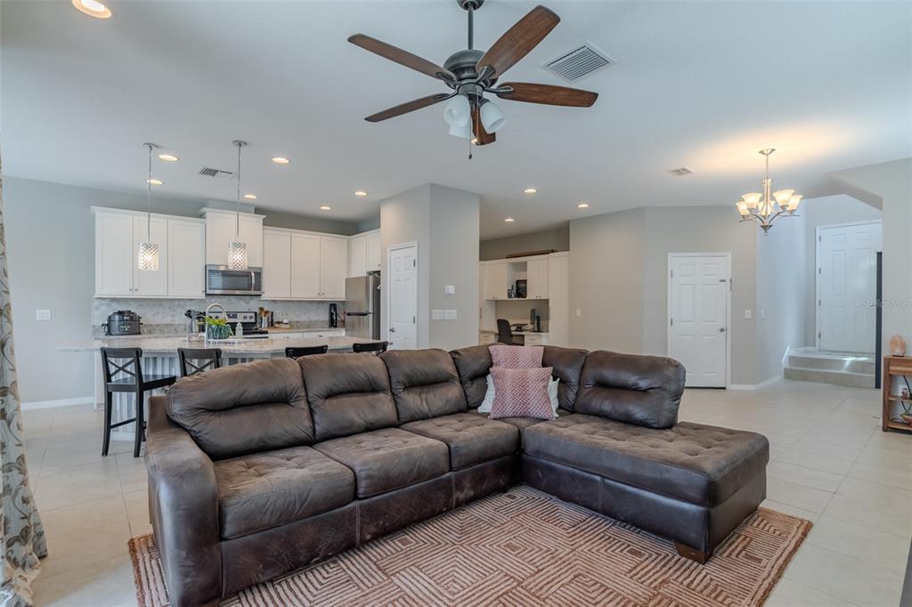 4730 Wandering Way Wesley Chapel, FL 33544 - Photo 18 of 61 a living room with furniture and kitchen view