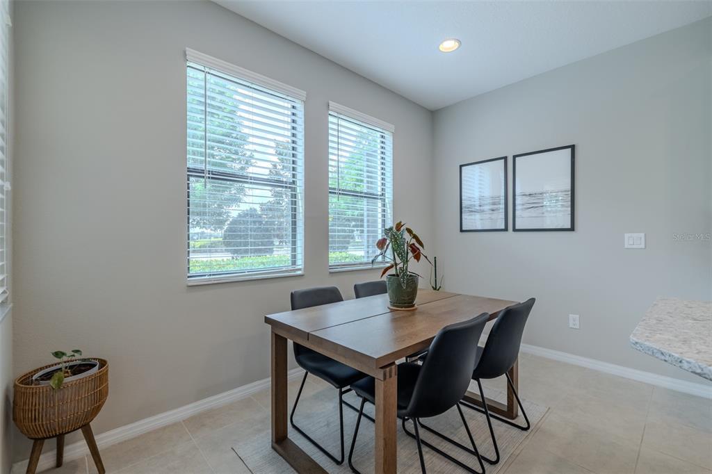 4730 Wandering Way Wesley Chapel, FL 33544 - Photo 20 of 61 a view of a dining room with a table and chairs