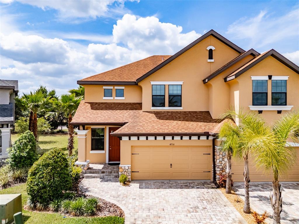 4730 Wandering Way Wesley Chapel, FL 33544 - Photo 2 of 61 a front view of a house with a yard and potted plants