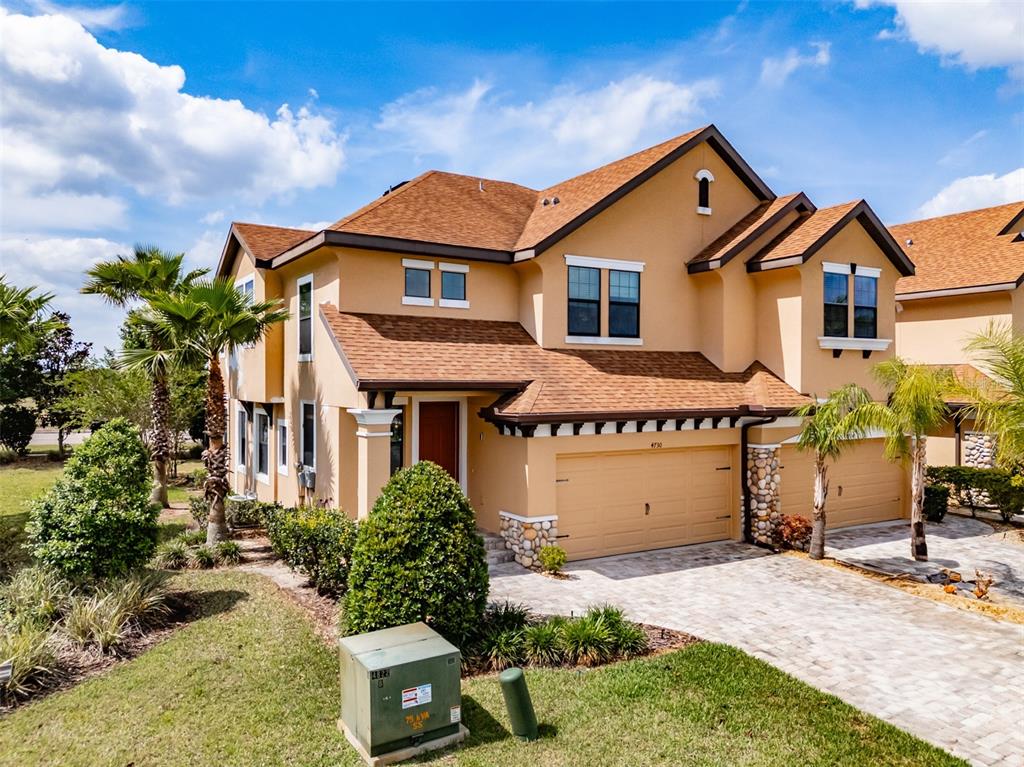 4730 Wandering Way Wesley Chapel, FL 33544 - Photo 3 of 61 a front view of a house with a yard and garage