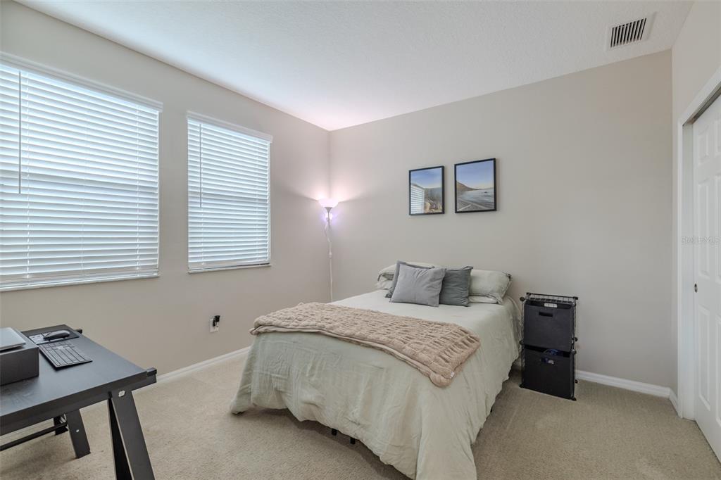 4730 Wandering Way Wesley Chapel, FL 33544 - Photo 33 of 61 a bedroom with a bed and a window