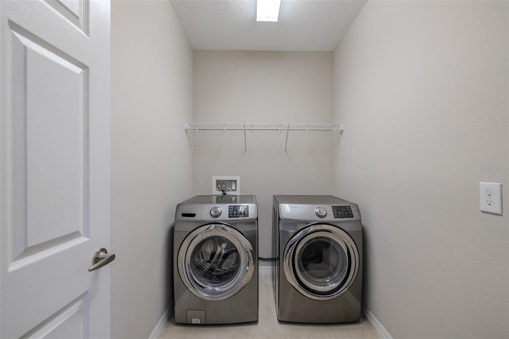 4730 Wandering Way Wesley Chapel, FL 33544 - Photo 38 of 61 a utility room with dryer and washer