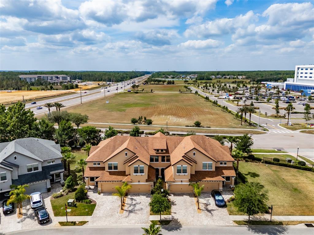 4730 Wandering Way Wesley Chapel, FL 33544 - Photo 39 of 61 an aerial view of a house with a lake view