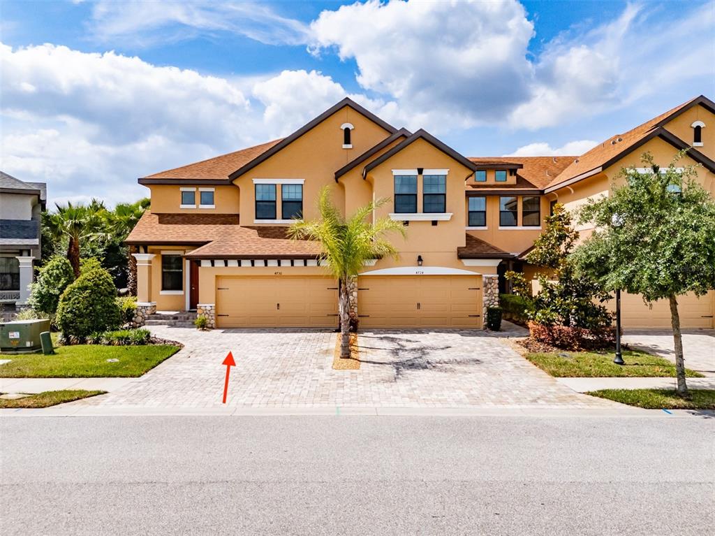 4730 Wandering Way Wesley Chapel, FL 33544 - Photo 53 of 61 a front view of a house with a yard and garage