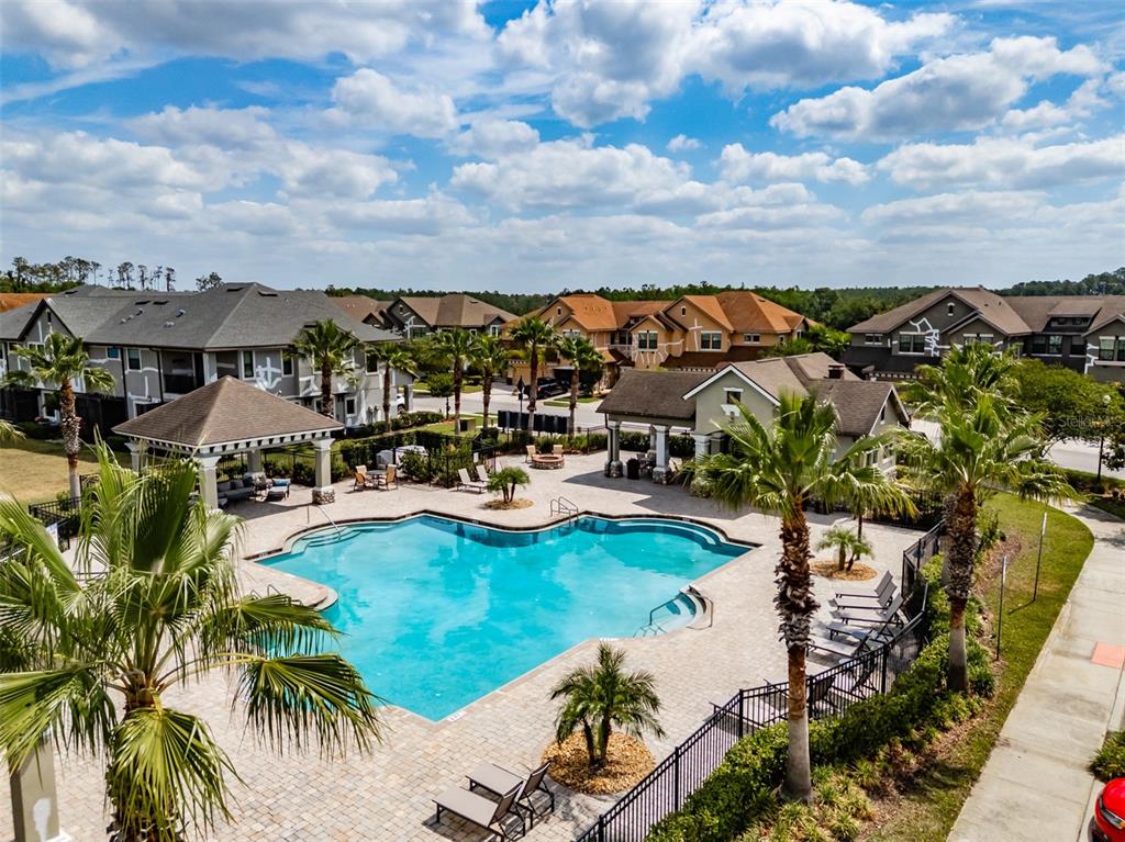 4730 Wandering Way Wesley Chapel, FL 33544 - Photo 59 of 61 a view of a swimming pool and mountains in the background