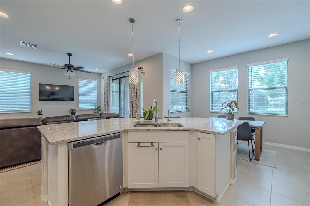 4730 Wandering Way Wesley Chapel, FL 33544 - Photo 7 of 61 a kitchen with sink cabinets and microwave