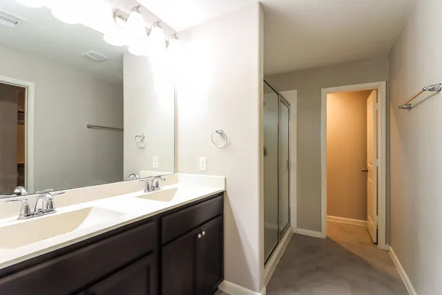 a bathroom with a double vanity sink a and mirror