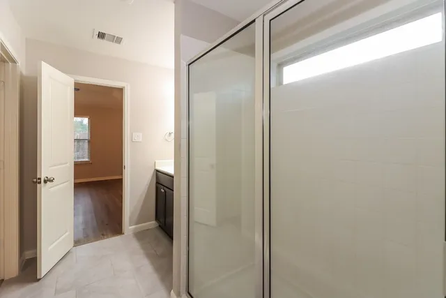 a view of a bathroom from a hallway