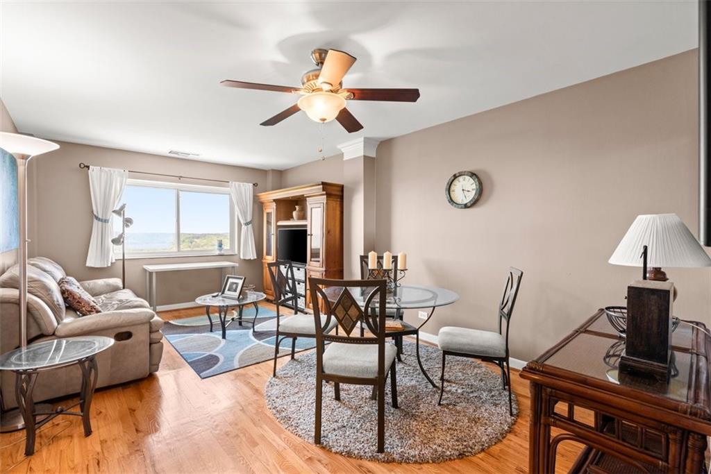 a dining room with furniture a chandelier and wooden floor
