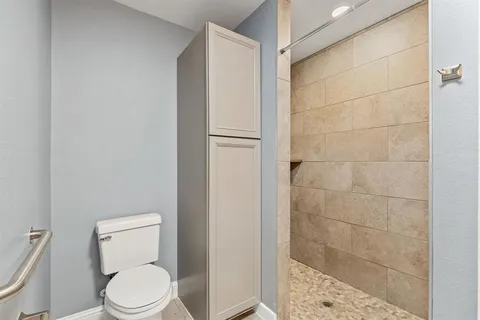 a white toilet sitting next to a bathroom sink