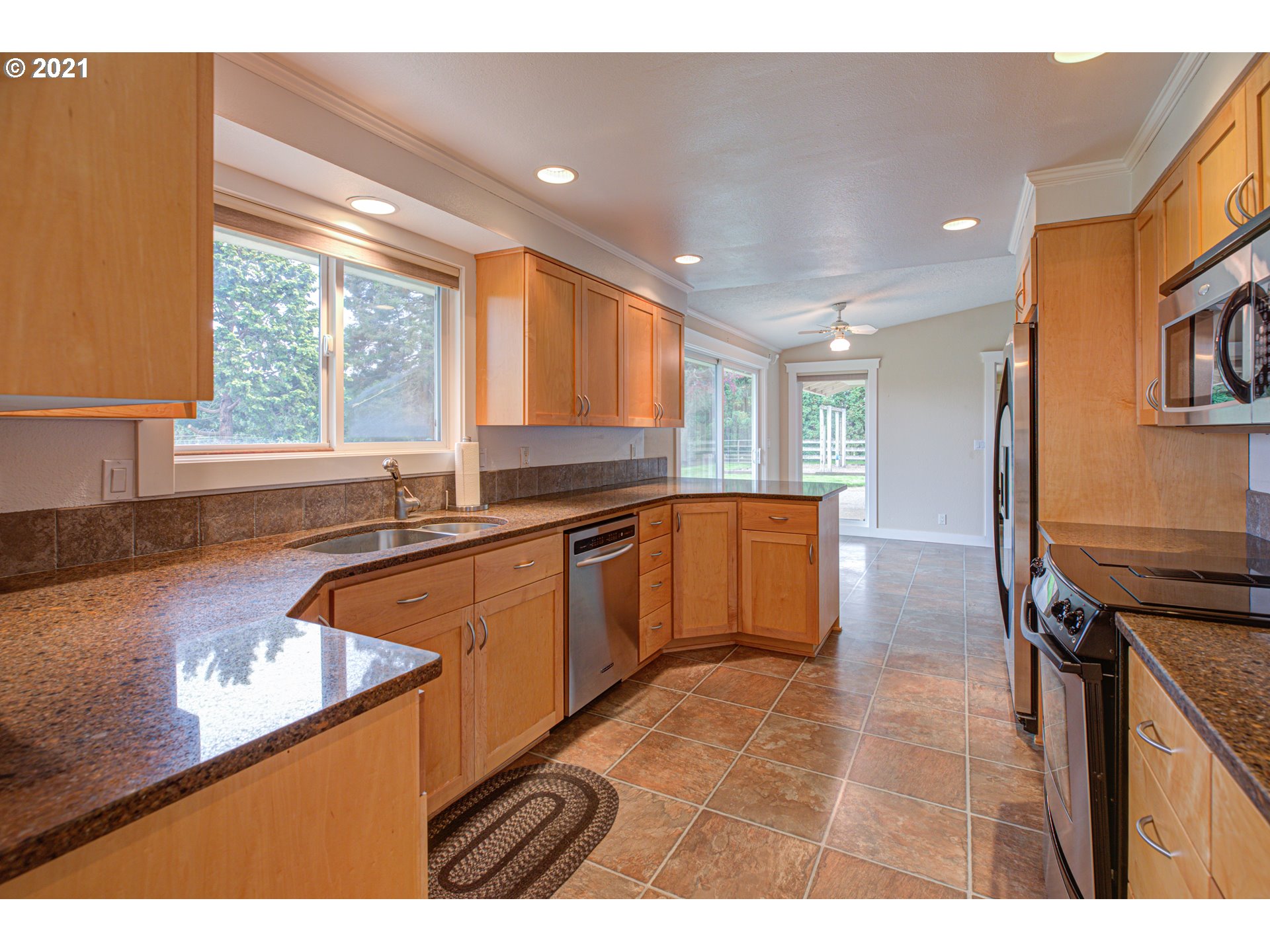 22900 South Haines Road Canby, OR 97013 - Photo 12 of 31 a kitchen with stainless steel appliances granite countertop a sink stove and refrigerator