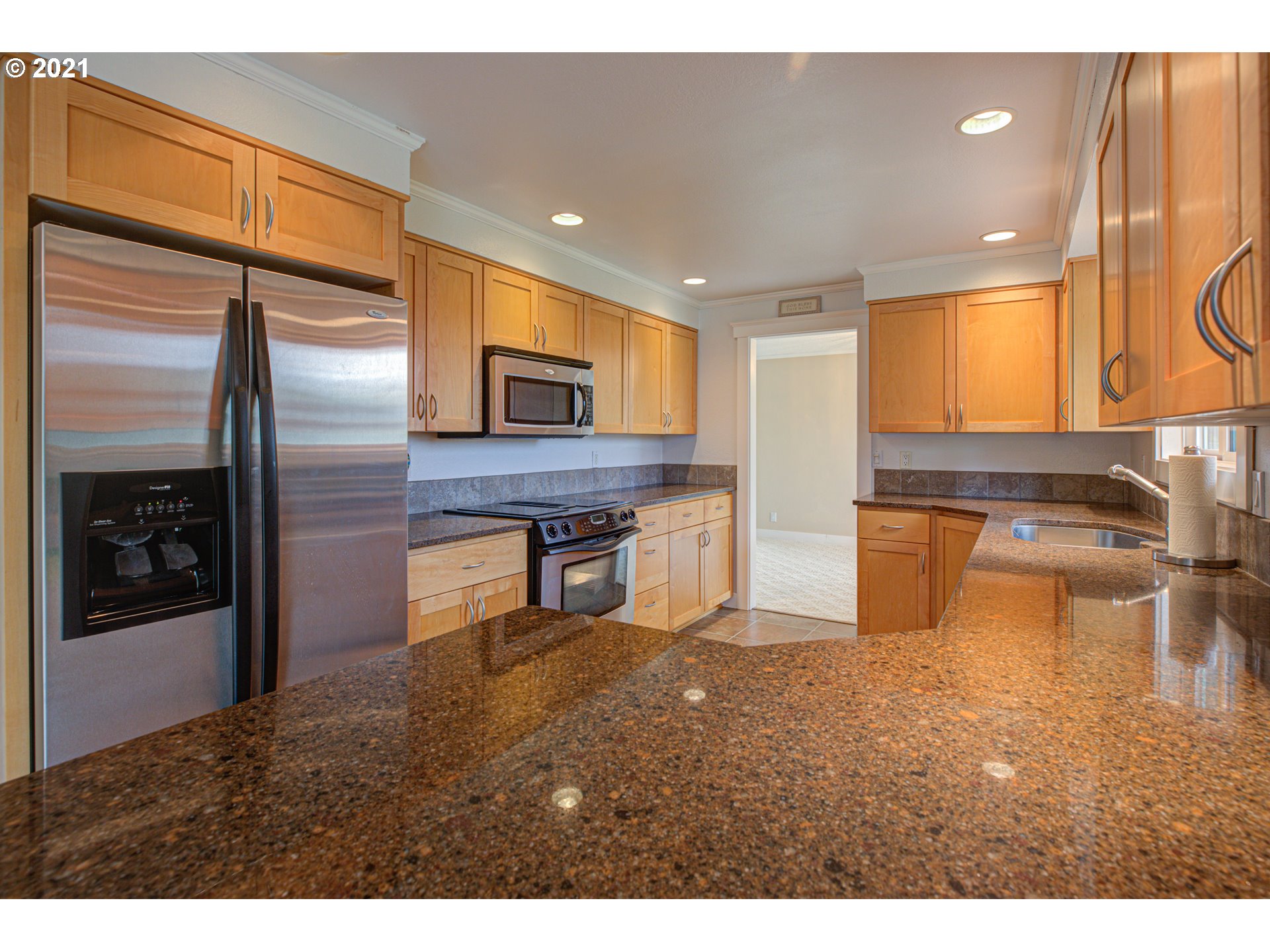 22900 South Haines Road Canby, OR 97013 - Photo 13 of 31 a kitchen with stainless steel appliances kitchen island granite countertop a refrigerator a stove and a sink with granite countertops