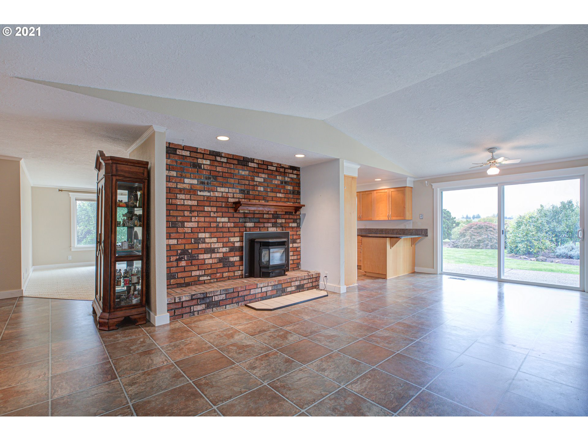 22900 South Haines Road Canby, OR 97013 - Photo 7 of 31 a view of an empty room with wooden floor and a fireplace