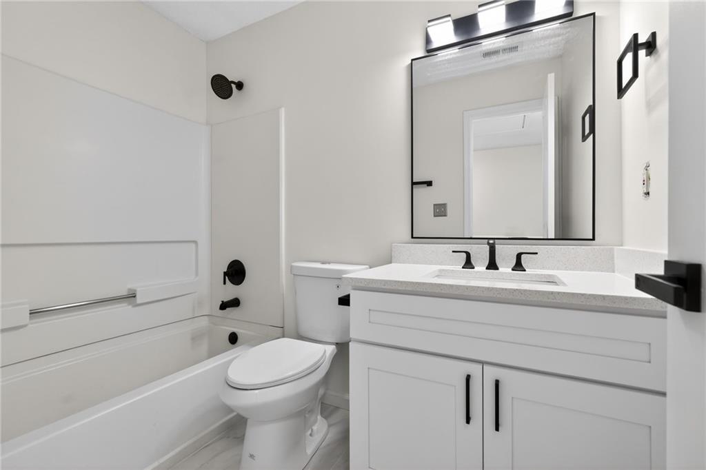 4166 Howell Park Road Duluth, GA 30096 - Photo 17 of 24 a bathroom with a sink a toilet and shower