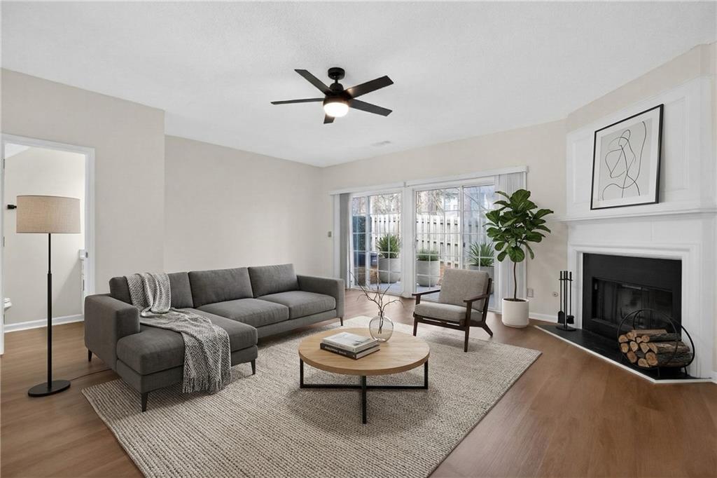 4166 Howell Park Road Duluth, GA 30096 - Photo 18 of 24 a living room with furniture and a fireplace