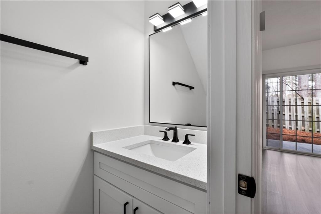 4166 Howell Park Road Duluth, GA 30096 - Photo 5 of 24 a bathroom with a sink and mirror