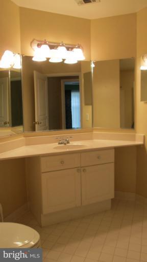 5565 Seminary Road, Unit 213 Falls Church, VA 22041 - Photo 6 of 8 a bathroom with a sink mirror vanity and toilet