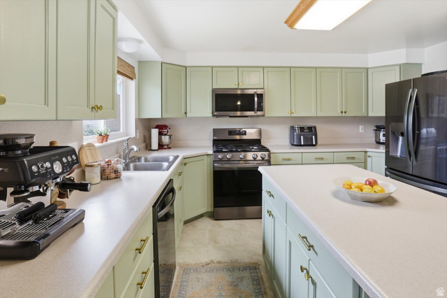 5108 South 2000th Street West Roy, UT 84067 - Photo 17 of 61 Kitchen featuring green cabinets, stainless steel appliances, and light countertops
