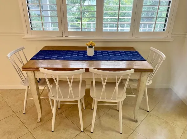 a bath room with a table and windows