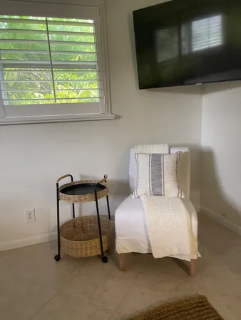 a bedroom with a bed and a chair