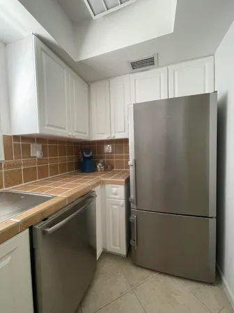 a white refrigerator freezer sitting in a kitchen