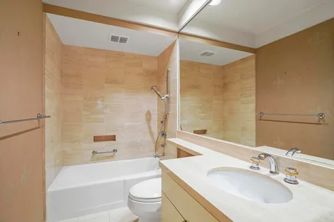 a bathroom with a sink mirror toilet and bathtub