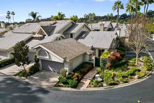 an aerial view of a house with a yard and potted plants