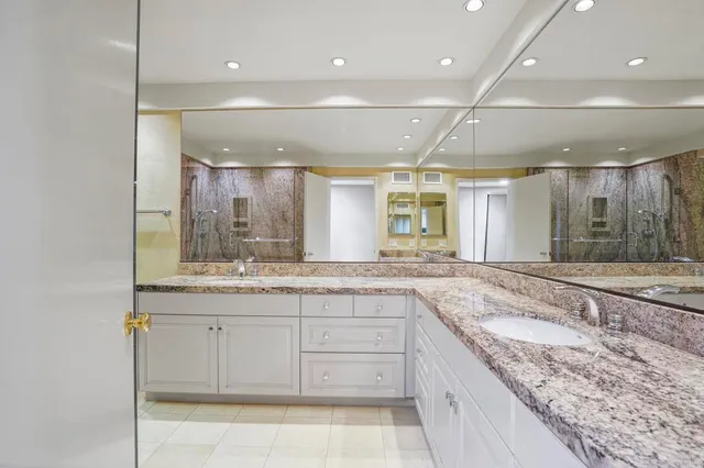 a bathroom with a granite countertop sink mirror and double