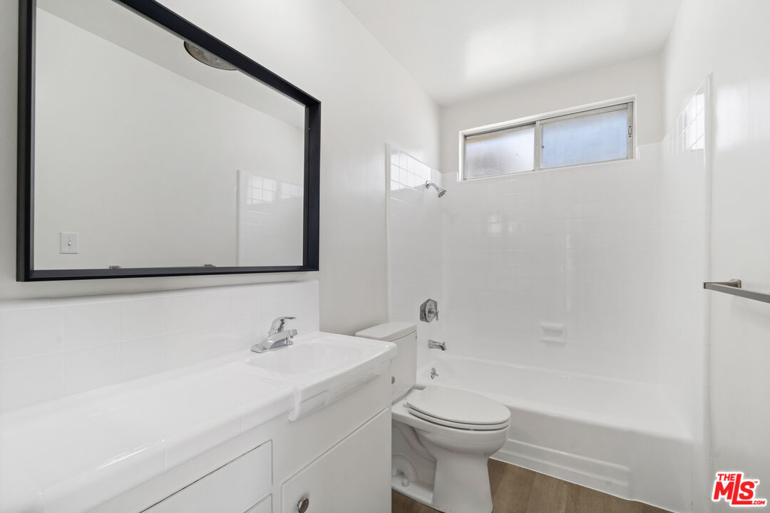 1236 McClellan Drive Los Angeles, CA 90025 - Photo 6 of 13 a bathroom with a sink a toilet and shower