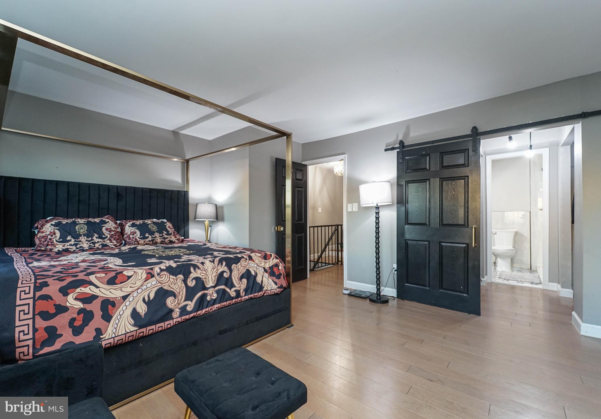 3013 Piano Lane, Unit 34 Silver Spring, MD 20904 - Photo 14 of 40 a bedroom with a large bed and a chandelier