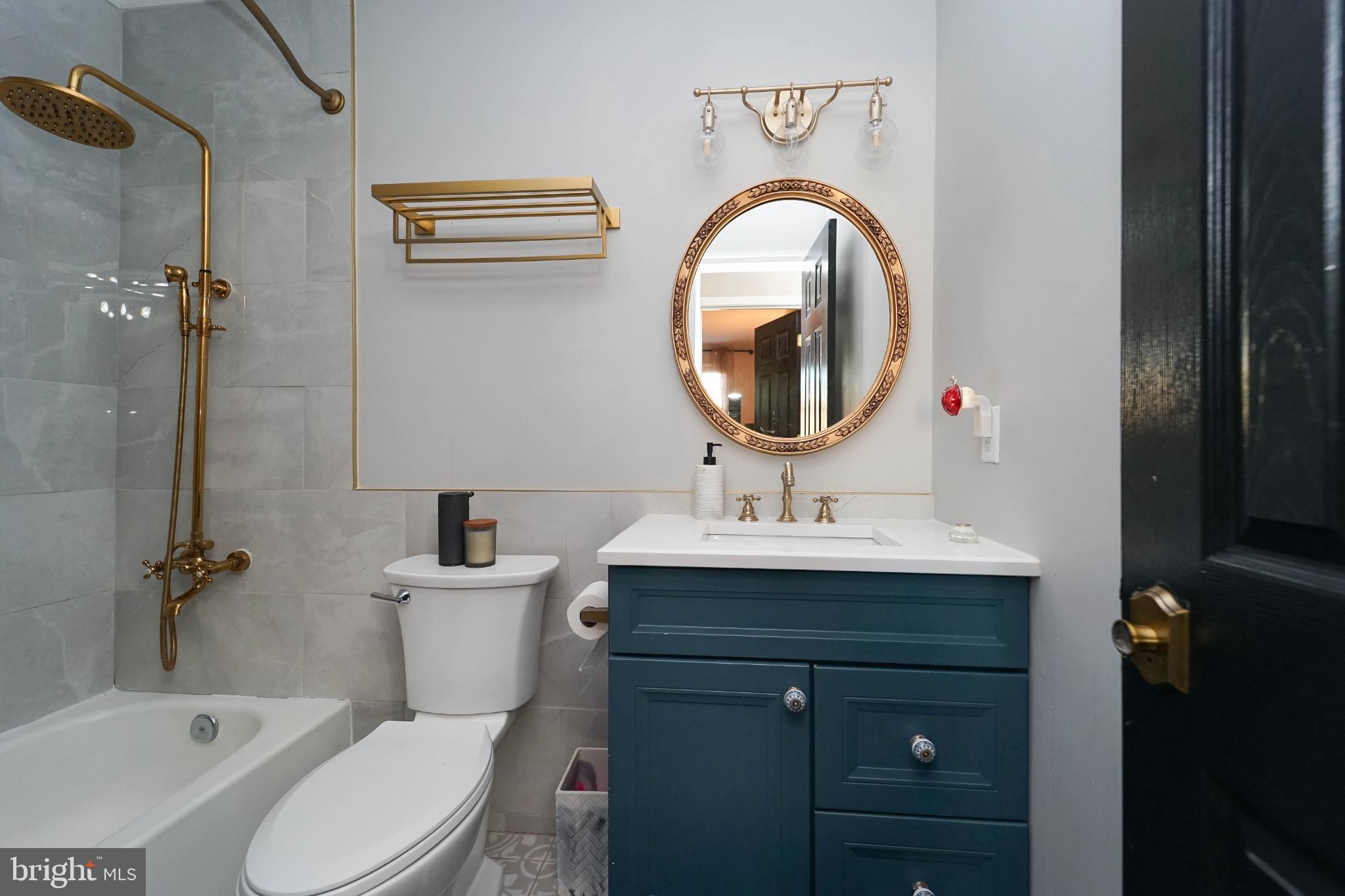 3013 Piano Lane, Unit 34 Silver Spring, MD 20904 - Photo 23 of 40 a bathroom with a sink a toilet and a mirror