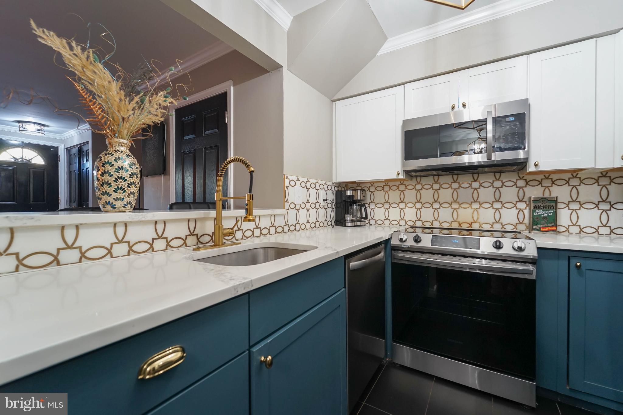 3013 Piano Lane, Unit 34 Silver Spring, MD 20904 - Photo 3 of 40 a kitchen with stainless steel appliances granite countertop a sink stove and microwave