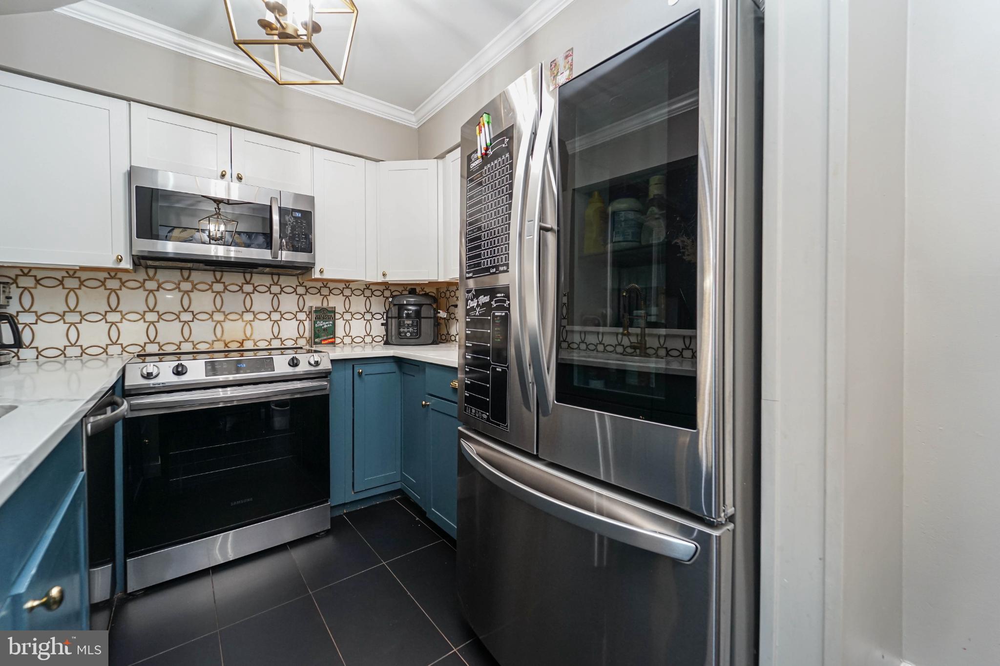 3013 Piano Lane, Unit 34 Silver Spring, MD 20904 - Photo 6 of 40 a kitchen with stainless steel appliances granite countertop a stove and a microwave
