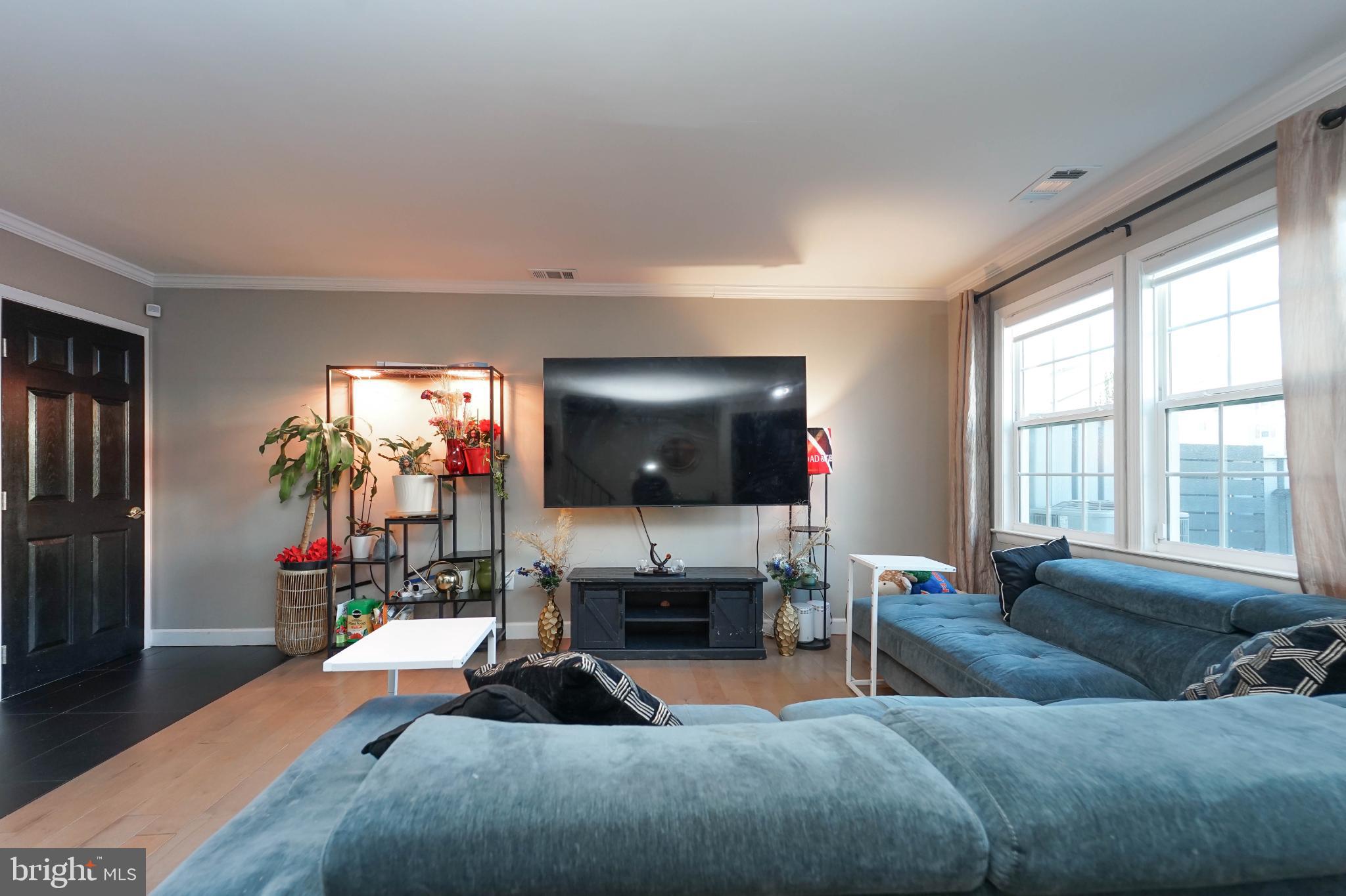 3013 Piano Lane, Unit 34 Silver Spring, MD 20904 - Photo 8 of 40 a living room with furniture and a flat screen tv