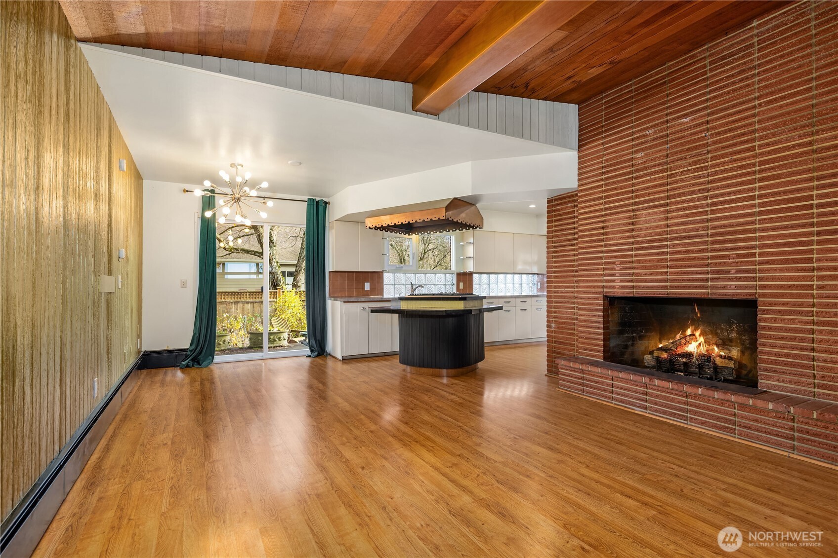 452 11th Street Blaine, WA 98230 - Photo 13 of 33 a open kitchen with a wooden floor and a fireplace
