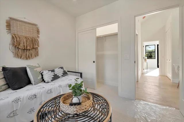 a bedroom with a bed and a painting on the wall