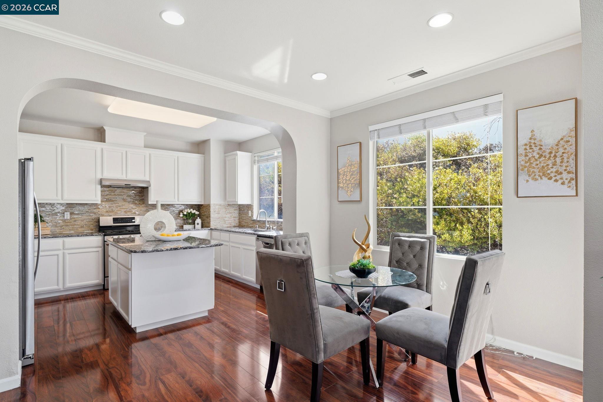 3217 Amaryllis Circle San Ramon, CA 94582 - Photo 11 of 48 a kitchen with white cabinets and wooden floor