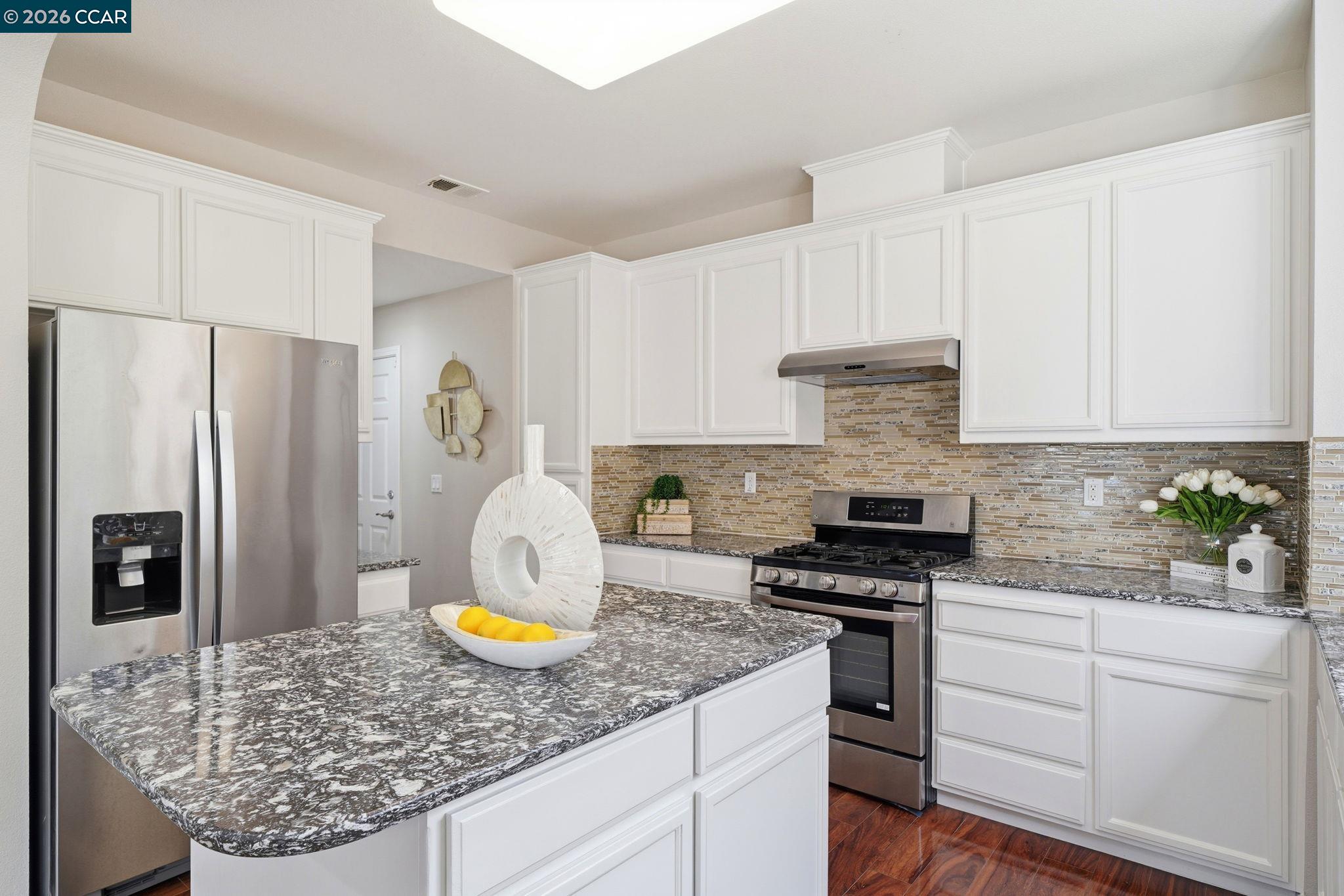 3217 Amaryllis Circle San Ramon, CA 94582 - Photo 14 of 48 a kitchen with a granite counter tops and white cabinets