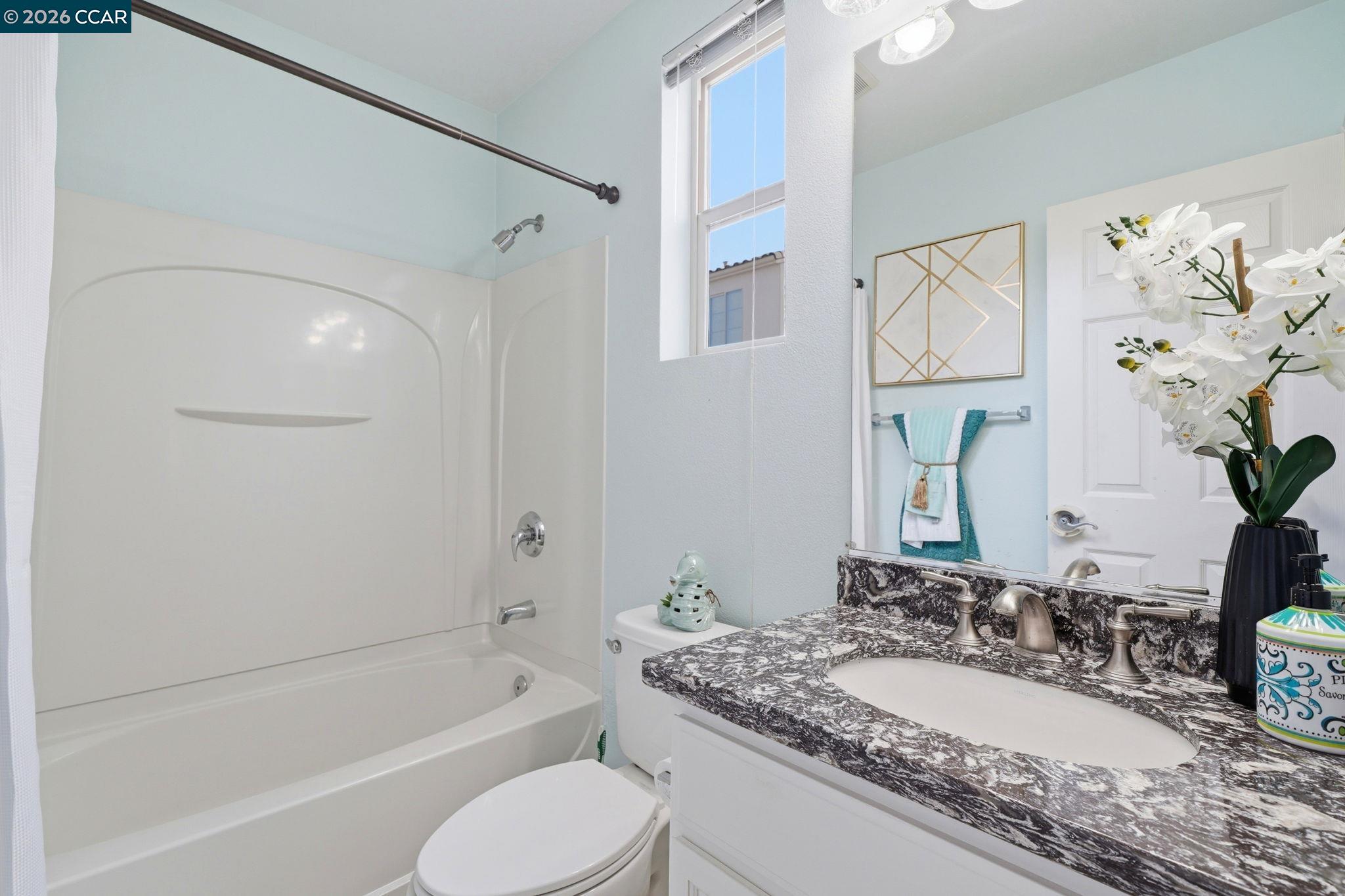 3217 Amaryllis Circle San Ramon, CA 94582 - Photo 33 of 48 a bathroom with a granite countertop tub sink and mirror