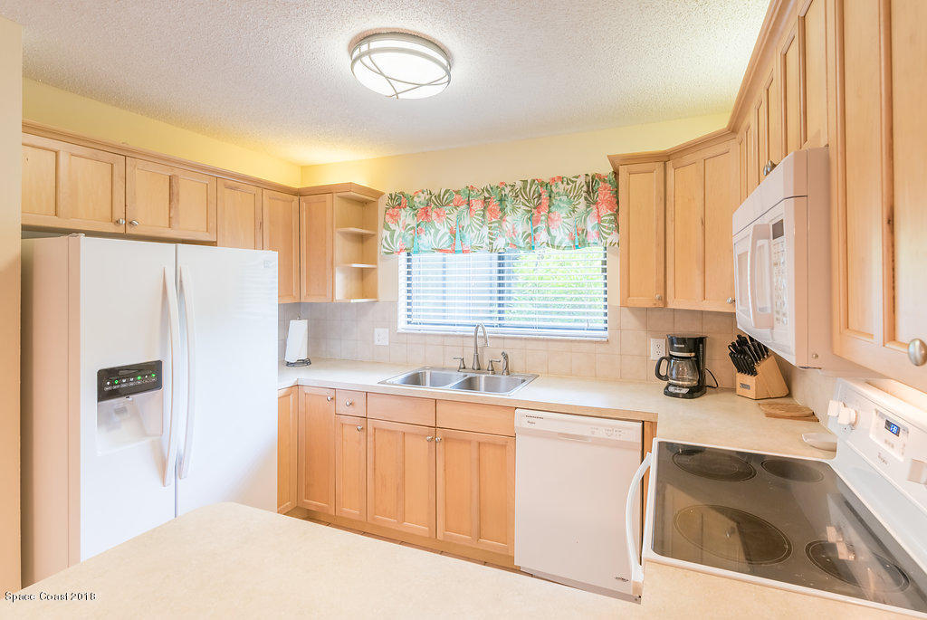 1679 Avery Road Northeast Palm Bay, FL 32905 - Photo 14 of 30 a kitchen with a sink stove and refrigerator