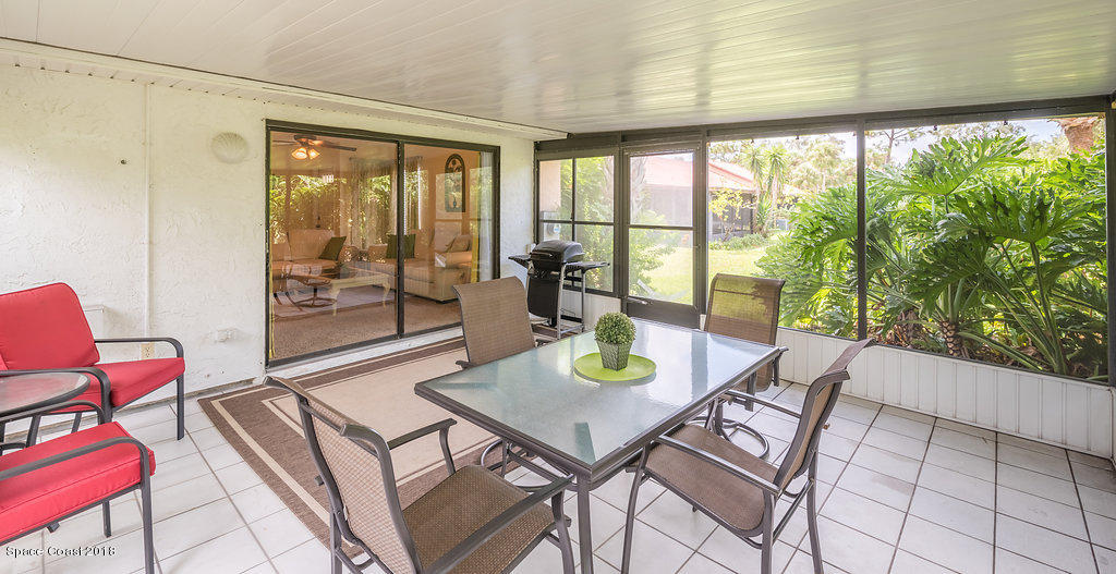 1679 Avery Road Northeast Palm Bay, FL 32905 - Photo 22 of 30 a living room with furniture and a floor to ceiling window