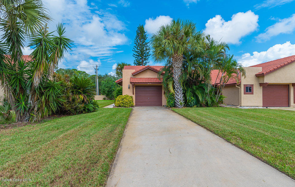 1679 Avery Road Northeast Palm Bay, FL 32905 - Photo 4 of 30 a front view of a house with a yard and garage