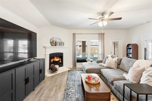 a living room with furniture a fireplace and window