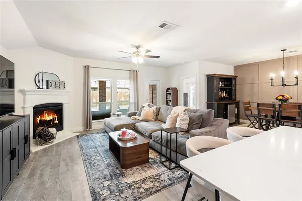 a living room with furniture fireplace and window