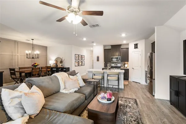 a living room with granite kitchen and kitchen view