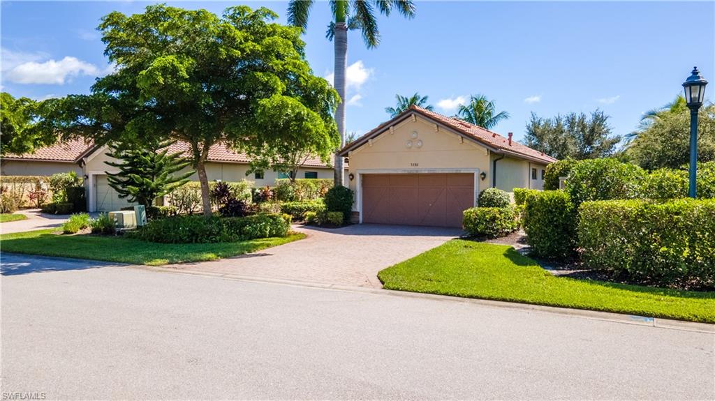 a front view of a house with a yard and garage