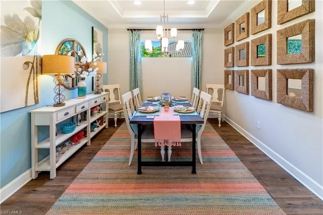 a dining room with furniture and a chandelier