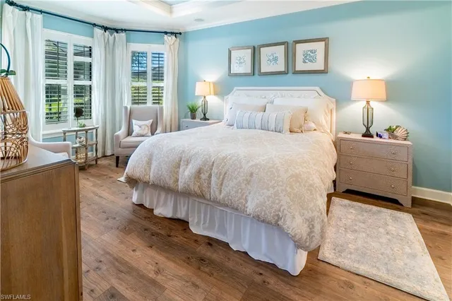 a bed sitting in a bedroom next to a window