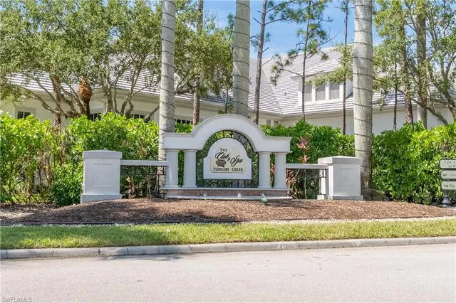 an aerial view of residential houses with outdoor space and trees all around